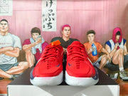 Front view of red Nike basketball shoes with navy accents and white soles