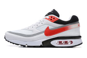 Side profile of a white Nike Air Max sneaker with red accents and a visible Air unit
