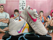 Angled view of light pink basketball shoes with multicolor side graphics and textured uppers.