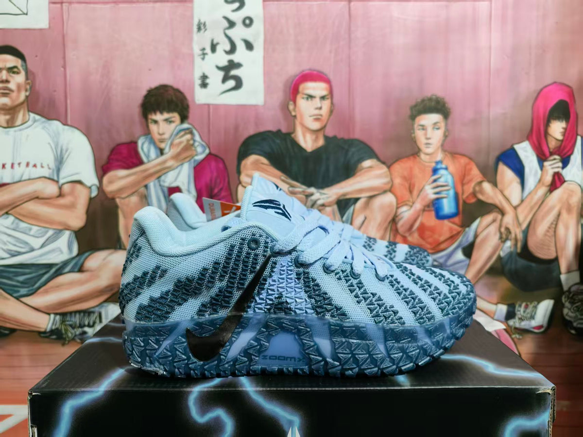 Pair of cobalt blue Nike basketball sneakers shown from the side on a black shoebox.