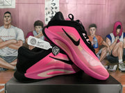 Angled side view of black and pink Nike basketball sneakers with visible swoosh branding and layered panels.