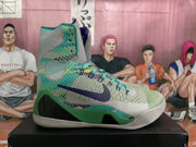 Side view of a high-top basketball sneaker with a purple Swoosh, green patterned panels, and a light-colored outsole.