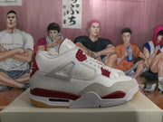 Side view of a white and grey Air Jordan 4-style sneaker with red accents and a gum outsole