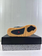 Bottom view of a sneaker showing a gum-colored rubber outsole with black traction sections and a red Jordan logo.