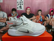 White Nike basketball shoe shown from the side with mesh-look upper, dark Swoosh, and Zoom midsole branding.