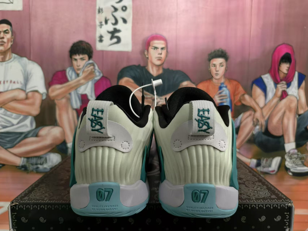 Rear view of cream and teal Nike sneakers showing black collars, teal heel accents and “07” markings.
