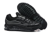 Black sneaker side view and outsole, showing the tread and gray side detailing.