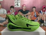 Side profile showing the textured green upper, black side detail and sculpted outsole.