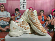 Angled view of the paired Nike KD basketball shoes highlighting the cream-and-khaki patterned uppers and layered midsoles.