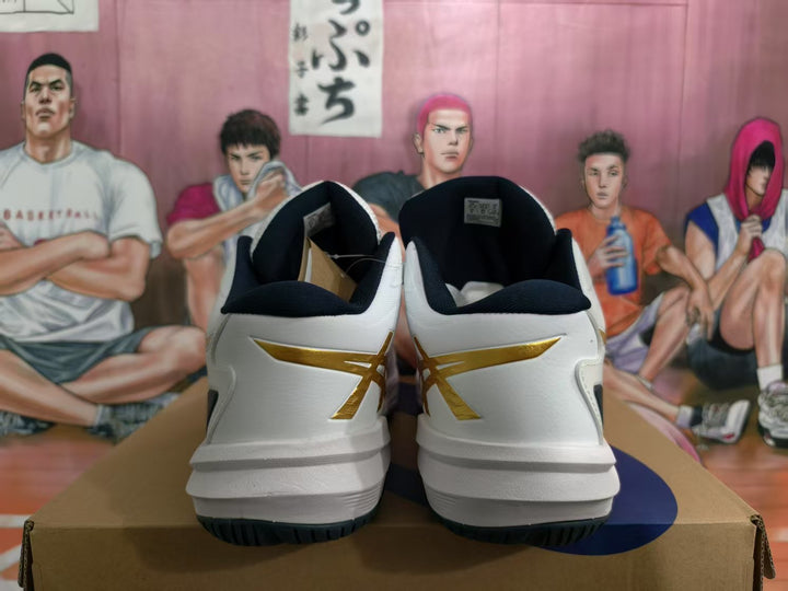 Rear view of white ASICS basketball sneakers with gold branding, black collars, and black outsole details on a shoebox.