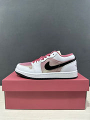 Side profile of one pink and white low-top sneaker displayed on a pink shoebox.