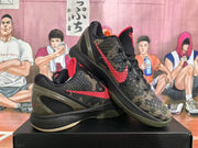 Angled view showing the textured camouflage uppers, red side branding, black midsoles, and olive heel sections.