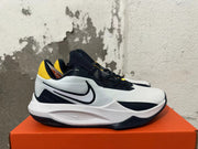 Side view showing the Swoosh logo on a white and navy Nike basketball shoe