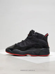 Side profile showing the black upper, glossy toe panel, ankle strap, and red outsole edge.