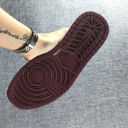 Close view of the burgundy rubber outsole and its circular traction pattern.