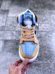 Top-down front view showing the perforated light blue toe box, tan laces, and padded tongue.