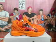 Side view of an orange Nike basketball sneaker with graphic detailing and visible Nike Zoom midsole branding.
