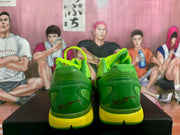 Rear view showing the green heel structure, yellow midsoles and visible red signature-style graphics.