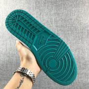Close view of the teal outsole and its circular tread pattern.
