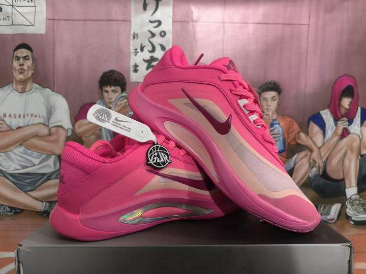 Pair of pink Nike basketball-style sneakers shown from a side angle on a shoebox.