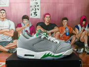 Side profile showing the gray upper, white laces, green geometric midsole accents, and visible air-window detail.