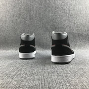 Rear view of both sneakers showing the black heel panels, grey collars and white midsoles.