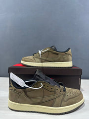 Side profile of the olive green sneaker with layered panels and a reversed Swoosh-style detail.