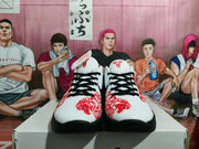 Front view of the pair showing white textured uppers, black laces, red ornamental graphics, and red tongue logos.