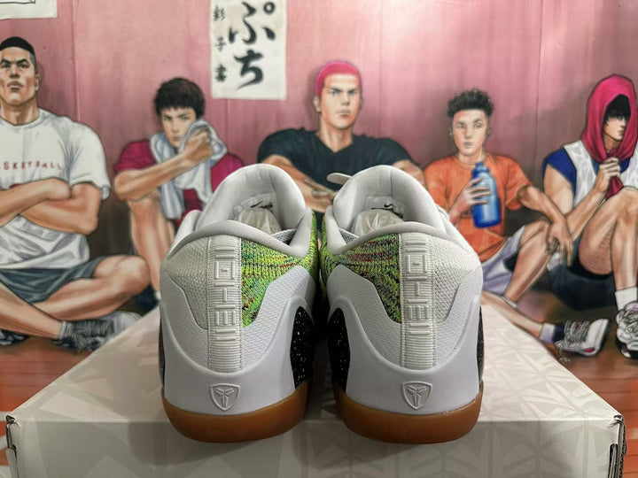 Rear view of white and green basketball sneakers with gum-colored soles and Kobe heel logos.