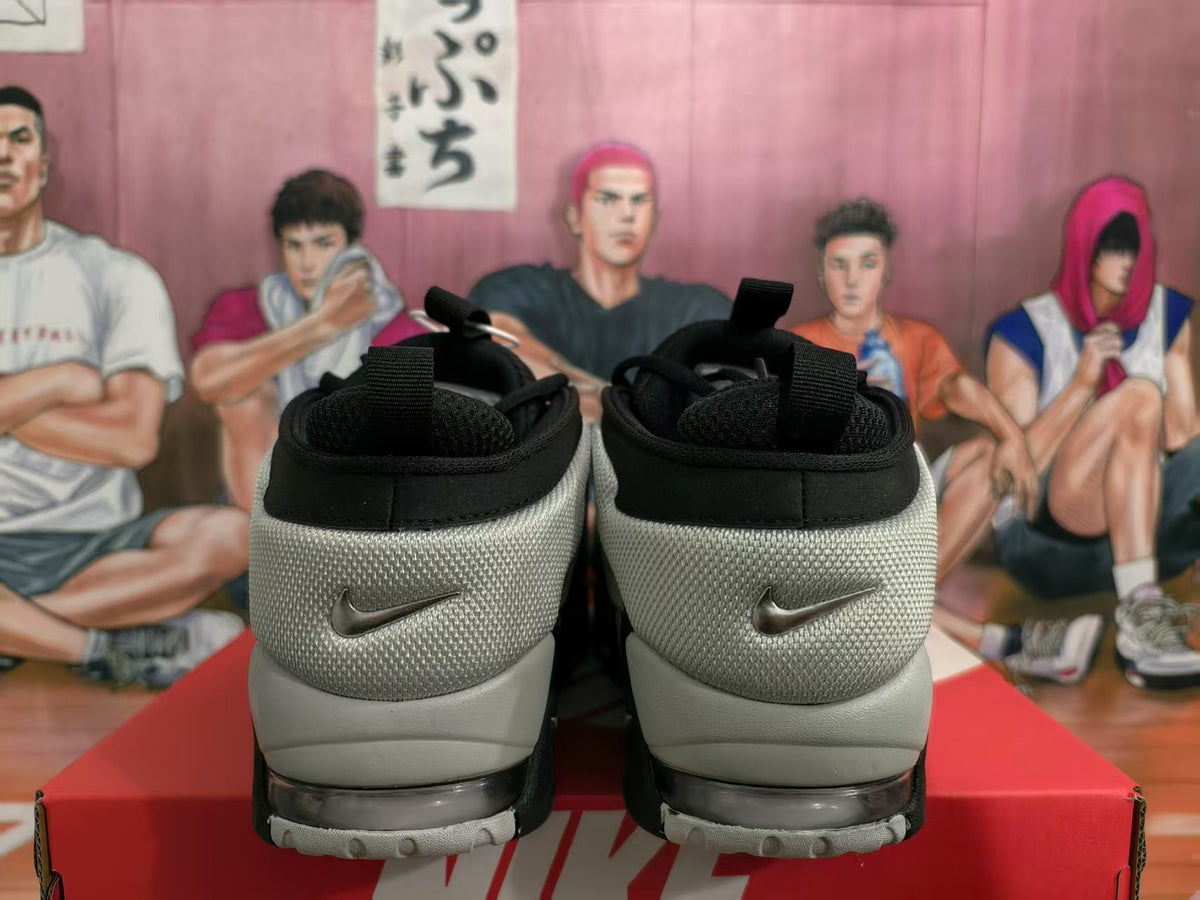 Rear view of black and white Nike sneakers showing padded collars, textured heel panels, and visible Swoosh logos.
