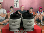 Rear view of black and white Nike sneakers showing padded collars, textured heel panels, and visible Swoosh logos.