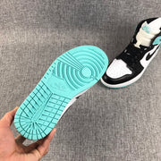 Underside view showing the mint green outsole and its circular and segmented traction pattern.