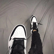 Top view showing the perforated white toe box, black overlays, and black laces.