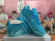 Angled view of blue Nike basketball sneakers with lace-up fronts and patterned uppers.