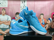 Angled view of the royal blue Nike basketball sneakers showing the lace-up construction, side Swoosh, heel details, and outsole pattern.