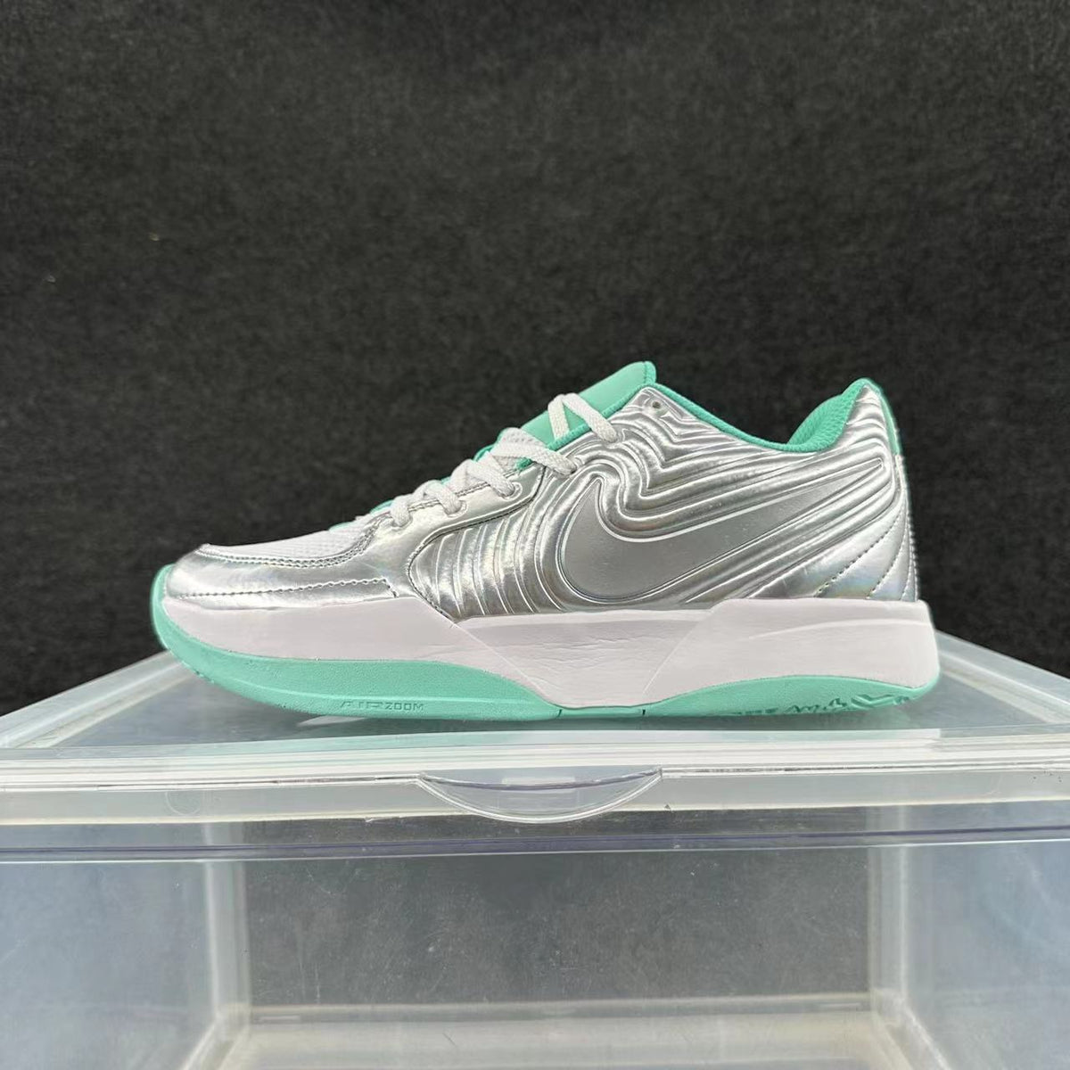 Side view of a silver Nike sneaker with mint-green accents, white laces, a white midsole and green outsole.