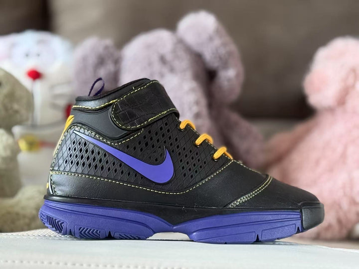 Side view of a black high-top kids' sneaker with purple accents, gold-yellow laces and a purple outsole.