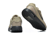 Rear and outsole views of tan and black Nike Air Max sneakers.
