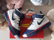 Top-down view of the sneakers resting on a red box, showing the contrasting upper panels and ankle straps.