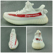 Composite view showing side, top, and front angles of the white sneaker with red graphics and ribbed sole.