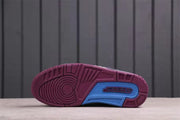 Outsole view showing the burgundy tread pattern and blue central traction section.
