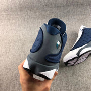 Rear view highlighting the grey heel panel and circular detail on an Air Jordan 13 Flint.