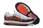 Side view of Nike sneakers beside the outsole, showing black, white, and bright orange details.