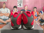 Rear view of gray, black, red, and white high-top basketball sneakers on a box.