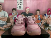 Front view of pink Nike basketball sneakers with tonal laces and light-colored soles displayed on a box.