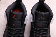 Close-up of the tongues with red Jumpman logos and black laces.