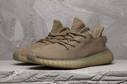 Front three-quarter view of a brown-tan low-top sneaker with matching laces and ribbed sole.