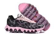 Nike Air Max DN8 sneakers shown from the side and underside, highlighting the pink sole and tread.