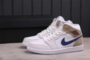Side profile of the white, dark blue, and tan Jordan Air Jordan 1 Mid sneakers.