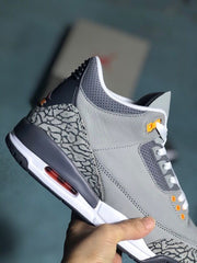 Side close-up of a grey sneaker showing elephant-print panels and the heel air unit